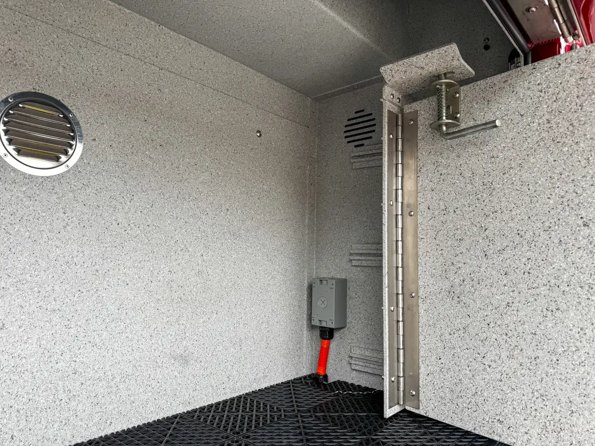 Side body detail above rear wheel showing closed fill doors and marker light.